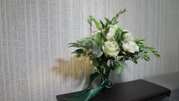 Bouquet of White Roses Flowers. Wedding Bouquet of Bride on Sofa. Morning Preparations of Newlyweds