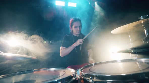 Male Drummer Is Rehearsing in the Clouds of Smoke