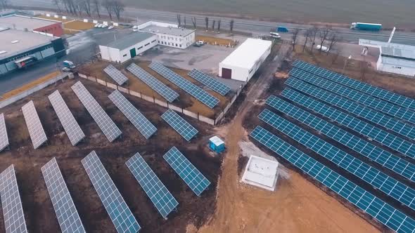 Solar batteries on the ground near factory or plant. Addicional sourse of green energy. Video from t
