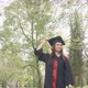 Pretty Brunette Girl Getting Off Mortarboard Jumping Throwing Up Outdoors in Park - VideoHive Item for Sale