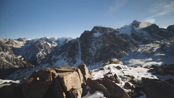 Man Running at the Mountain with Snow