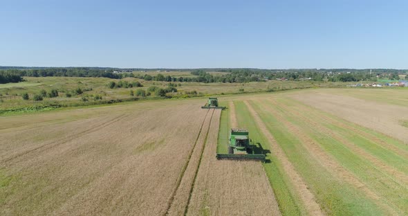 Combine Harvester on Wheat Field