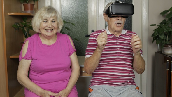 Grandfather and Grandmother with VR Headset Helmet Play Games, Watch Virtual Reality 3D 360 Video