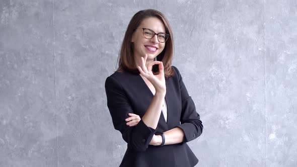 Portrait of Happy Young Business Woman Isolated on Gray Background