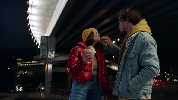 Positive Couple Eating Snacks Food at Night