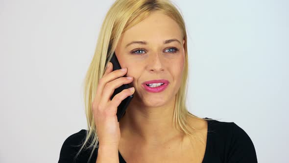 A Young Attractive Woman Talks on a Smartphone with a Smile - Closeup - White Screen Studio