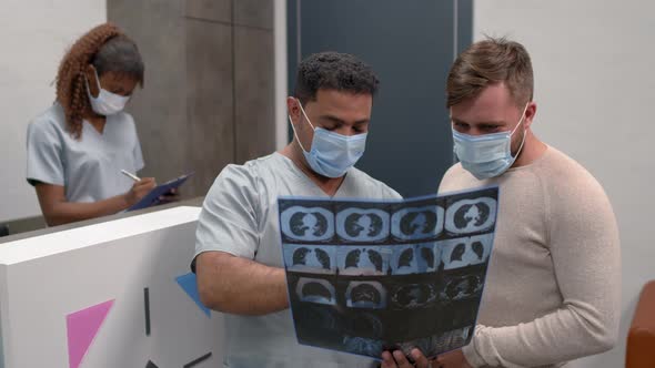 Doctor and Patient Looking at CT Scan of Lungs