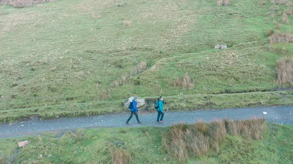 Aerial view of people hiking and climbing Snowdon mount in Wales on a sunny d