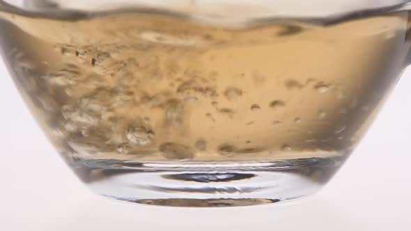 Closeup. Tea Is Poured Into a Glass Cup