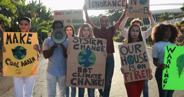 Young group of demonstrators on road from different culture and race protest for climate change