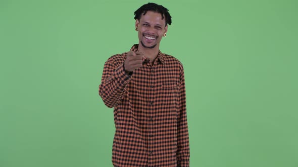 Happy Young Handsome African Man Pointing at Camera