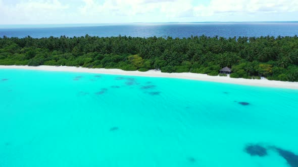 Wide birds eye abstract shot of a white paradise beach and aqua blue water background in hi res 4K