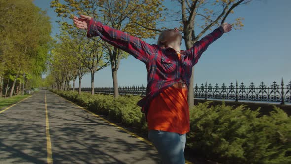 Carefree Pretty Hipster Woman Enjoying Skateboarding Outdoors