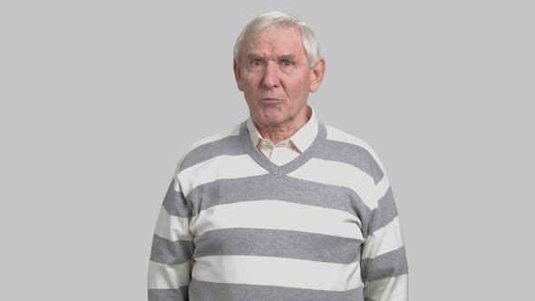 Frustrated Aged Man on Grey Background