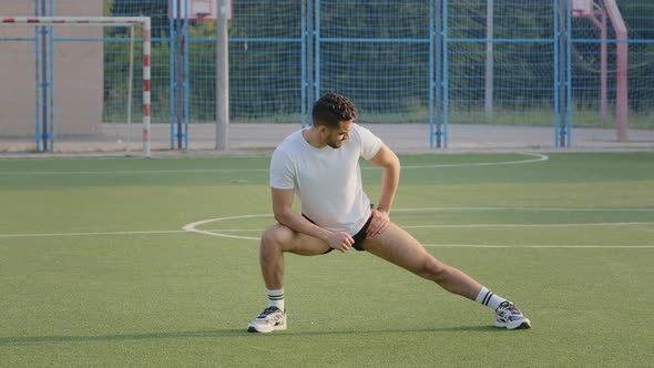 Young Athletic Hispanic Athlete with Good Figure Training Before Match Doing Stretching Exercise
