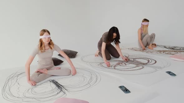 Girls Paint an Abstract Picture with Pastels During Yoga Using Their Hands To Draw