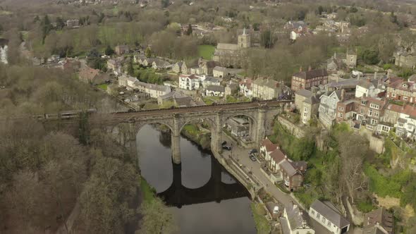 drone shot of train crossing a bridge