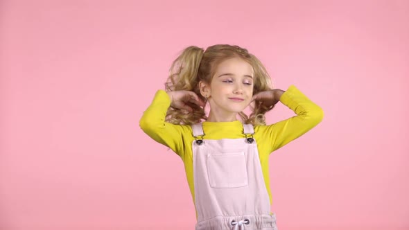 Beautiful Sweet Little Girl Is Playing with Her Hair. Slow Motion