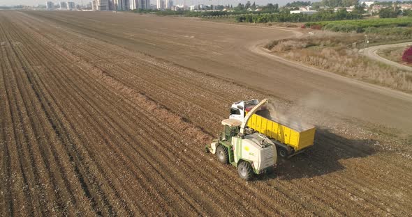 Aerial view of a tractor and a lorry working in a field, Kibbutz Saar, Israel.