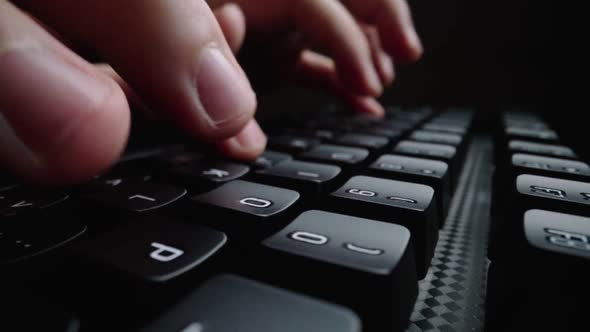 Close-up typing on keyboard with man fingers. Macro soft focus dolly shot.