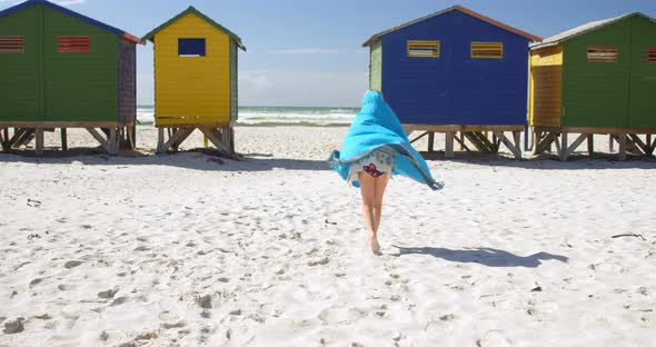 Girl with towel walking in the beach 4k