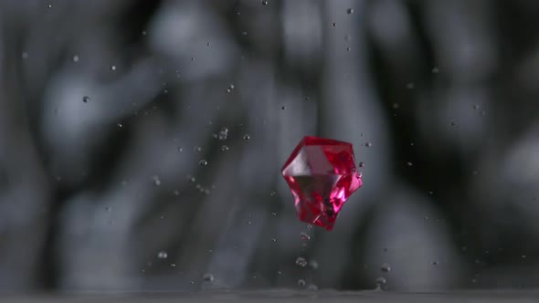 Colored cubes falling and bouncing on puddle, Slow Motion