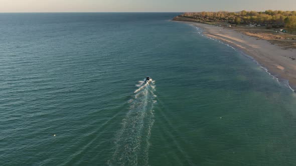 Aerial fly over speed boat in seawater