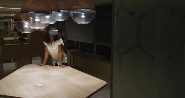Businesswoman using VR helmet in a modern office