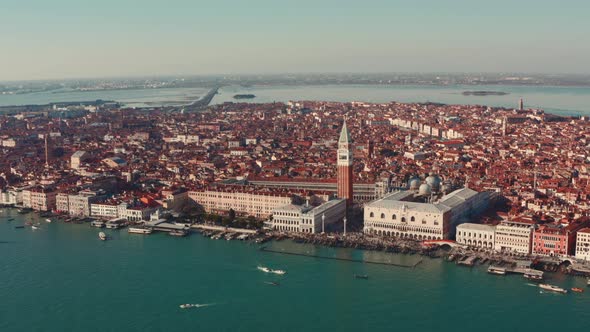 Close up dolly forward drone shot over Venice lagoon towards St Marco Square tower