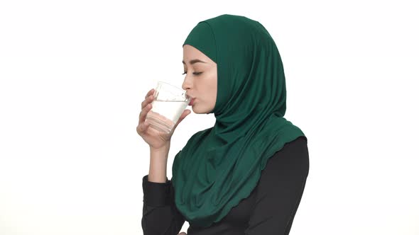 Portrait of Beautiful Arabic Woman in Hijab Drinking Still Filtered Water From Glass Being Thirsty