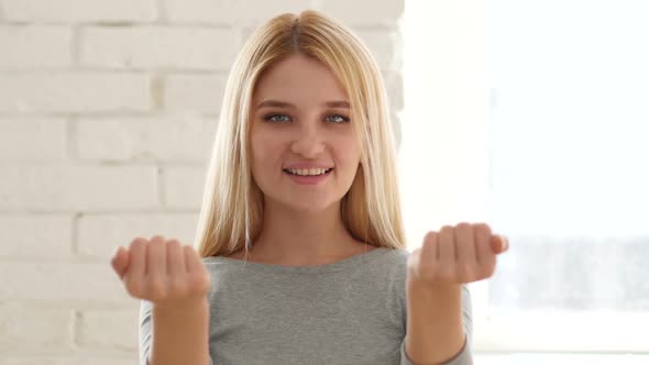 Young Woman Inviting Customers with Both Hands