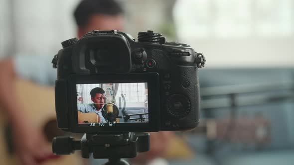 Camera Display With Asian Boy Playing Guitar And Sing A Song While Streaming