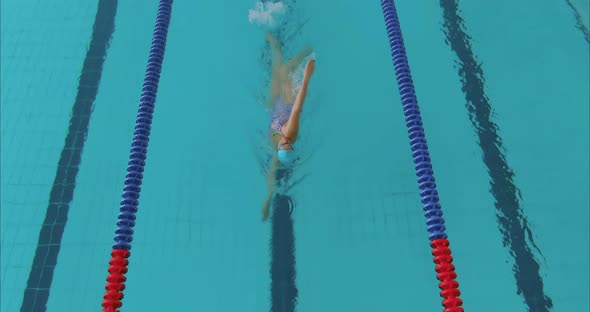 Young Woman Crawl on Her Back Doing Sports in the Sports Pool