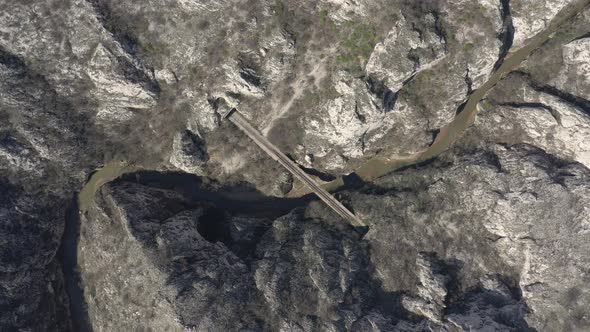 Descending on railroad track and winding river  canyon 4K aerial video