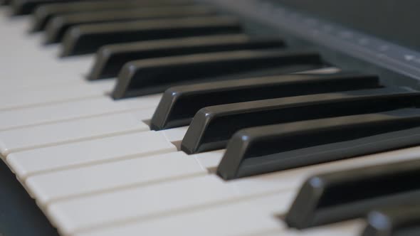 Electric piano  keyboard keys shallow DOF musical 4K 2160p 30fps UHD pan footage - Panning over synt