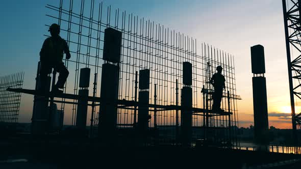 The Building in Progress with Male Engineers Working on It alt