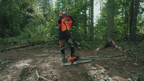 Portrait of a Woman Logger Standing in the Forest Female Specialist in Protective Gear Puts on