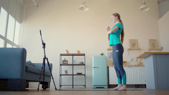 Athletic Woman Conducts Training Online. Concept Exercise at Home Via Smartphone.