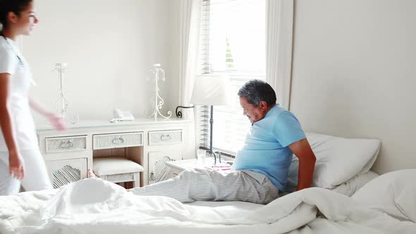 Female doctor assisting senior man in walking 4k