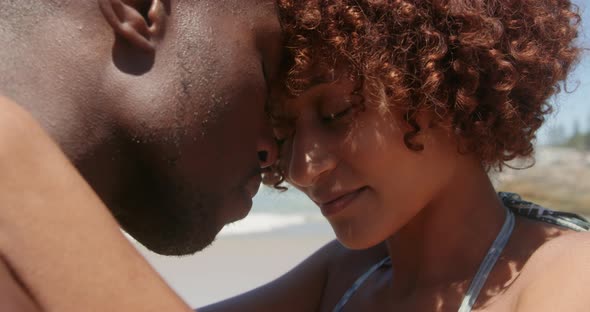 Couple embracing each other on beach in the sunshine 4k