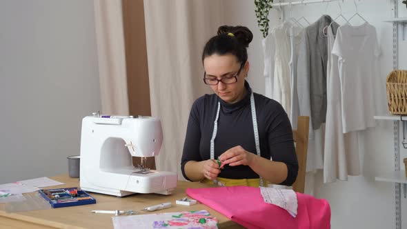 Female Tailor Working at Her Workplace in Atelier