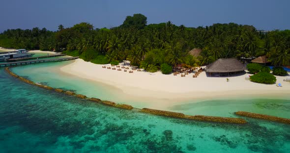 Tropical birds eye travel shot of a sandy white paradise beach and blue ocean background in best qua