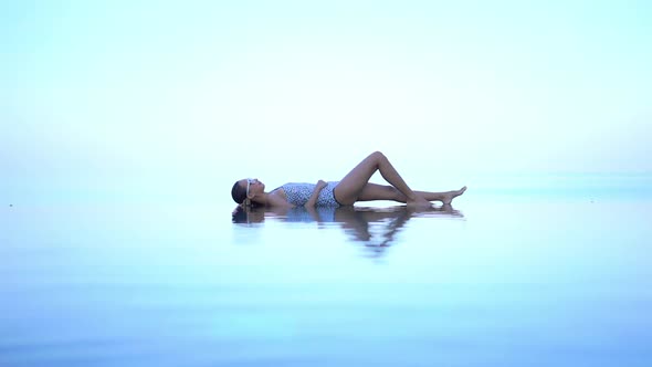 Young asian woman enjoy around outdoor swimming pool for leisure