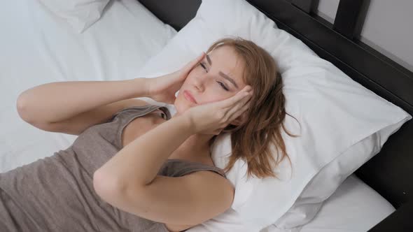 Woman Lying in Bed with Headache, Pain in Head