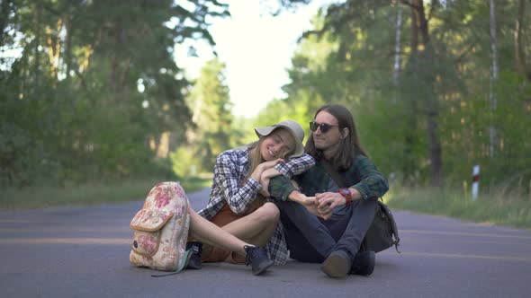 Millennial Tourist Happy Couple in Plaid Hipster Shirts Hugging and Enjoing Travel Together Sitting