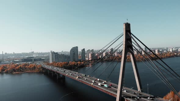 Busy Traffic on Concrete Bridge Over the Industrial City River