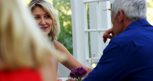 Couple interacting while having wine in restaurant