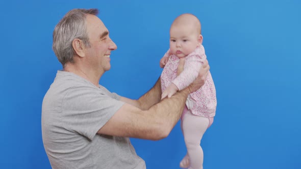 Funny Games and Laugh of Caucasian Old Man and Baby Kid in Domestic Comfort