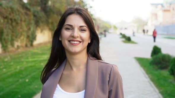 Beautiful Brunette Businesswoman In Business Clothes Walks In The City