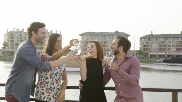 Friends clinking champagne glasses outdoors